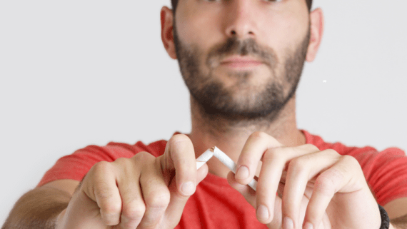 Un home que trenca una cigarreta. Vol deixar de fumar